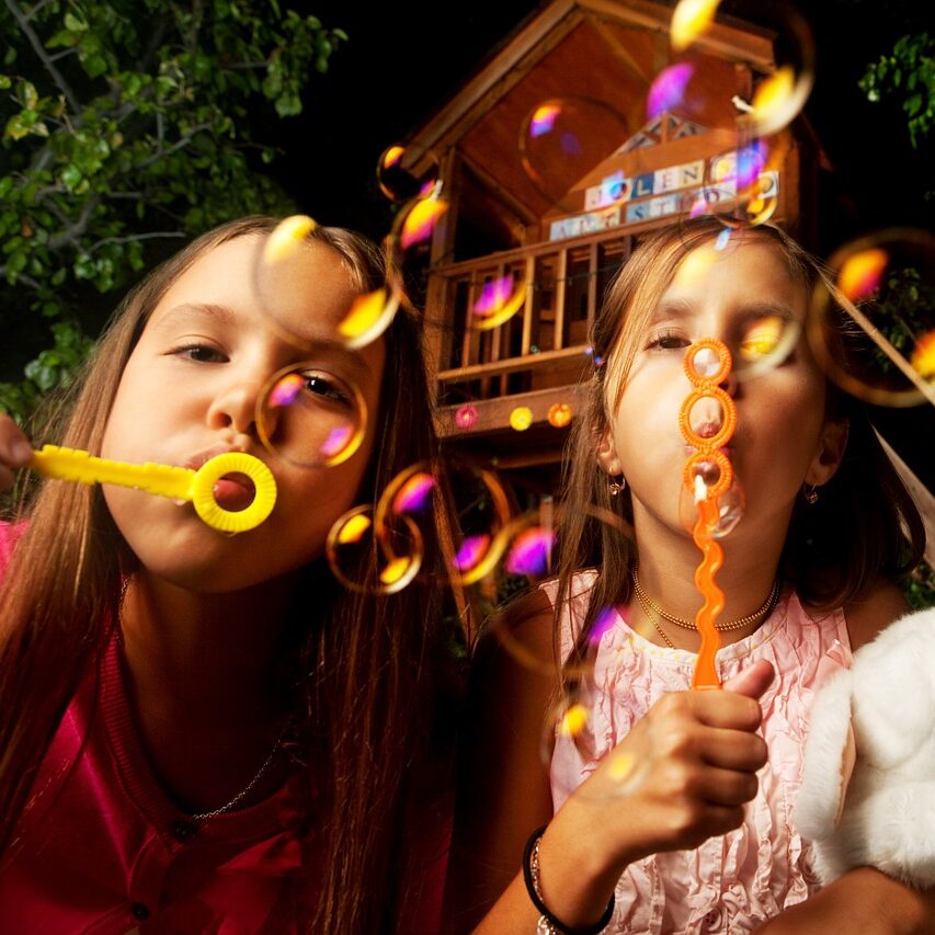 A picture of two girls blowing bubbles in the air as a placeholder while position is vacant.
